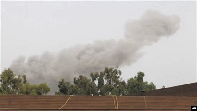 A smoke plume rises into the sky over Tripoli, Libya, on  June 7, 2011 following an airstrike