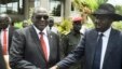 South Sudan's First Vice President Riek Machar, left, and President Salva Kiir shake hands following the first meeting of a new transitional coalition government, in the capital, Juba, April 29, 2016. 