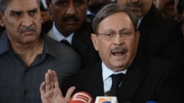 Pakistani Law Minister Farooq H Naik talks with media representatives after appearing at the Supreme Court in Islamabad, October 5, 2012. 