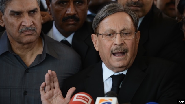 Pakistani Law Minister Farooq H Naik talks with media representatives after appearing at the Supreme Court in Islamabad, October 5, 2012. 