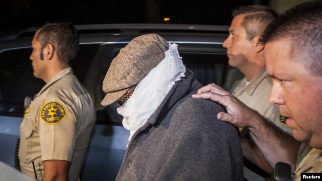 Nakoula Basseley Nakoula (C) is escorted out of his home by Los Angeles County Sheriff's officers in Cerritos, California, September 15, 2012. 