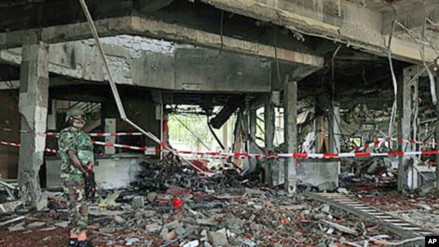 A Nigerian soldier secures the area at the United Nation's office following a suicide car bomb attack in Abuja, Nigeria, Aug. 27, 2011.