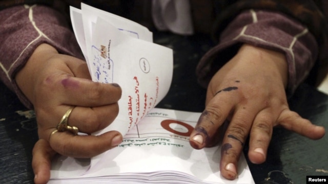 An official counts ballots after polls closed during the final stage of a referendum on Egypt's new constitution in Bani Sweif, about 115 km (71 miles) south of Cairo December 22, 2012.