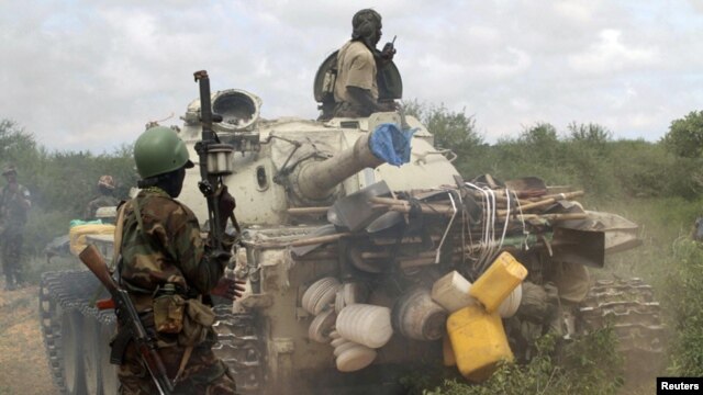 African Union Mission (AMISOM) forces patrol after fighting between insurgents and government soldiers on the outskirts of Mogadishu, Somalia, May 22, 2012. 