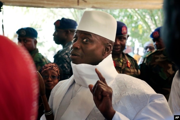 In a Thursday, Dec. 1, 2016 file photo, Gambia's president Yahya Jammeh shows his inked finger before voting in Banjul, Gambia.
