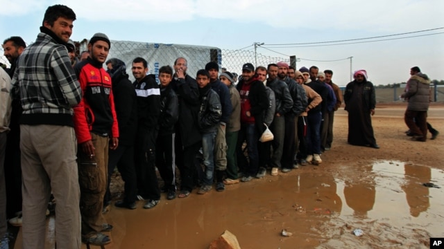 Newly arrived Syrian refugees wait their turn to receive mattresses, blankets and other supplies, and to be assigned to tents, at the Zaatari Syrian refugees camp in Mafraq, near the Syrian border with Jordan, Jan. 28, 2013.