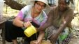 Sara Laskowski , left, gets a cooking lesson from her Peace Corps ‘host mother’ in Dubreka, Guinea. Since shortly after the Peace Corps pulled volunteers from Ebola-afflicted countries, the young American has promoted an Ebola aid fund for the National Pe