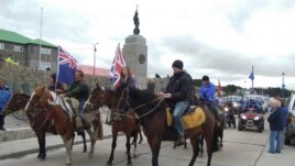 Residents, some carrying British flags, parade during a rally in support of United Kingdom control over the islands in Port Stanley, Falkland or Malvinas Islands Sunday, March 10, 2013