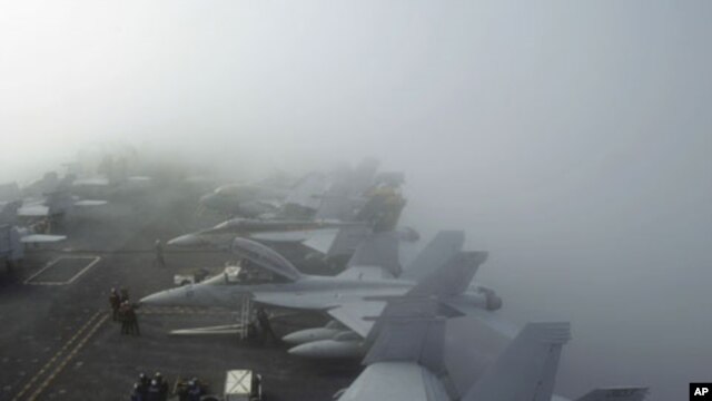 U.S. Navy F/A-18F Super Hornet fighter jets sit in heavy fog on the deck of the USS George Washington, during a joint military exercise off South Korea's West Sea. (File)