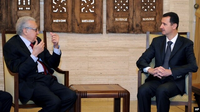 In this photo released by the Syrian official news agency SANA, Syrian President Bashar al-Assad, right, meets with U.N. Arab League deputy to Syria, Lakhdar Brahimi in Damascus, Syria, December 24, 2012. 