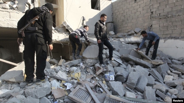 Free Syrian Army fighters and civilians search for bodies under rubble after an air strike by a fighter jet loyal to Syrian President Bashar al-Assad in Aleppo's al-Marja district December 31, 2012.