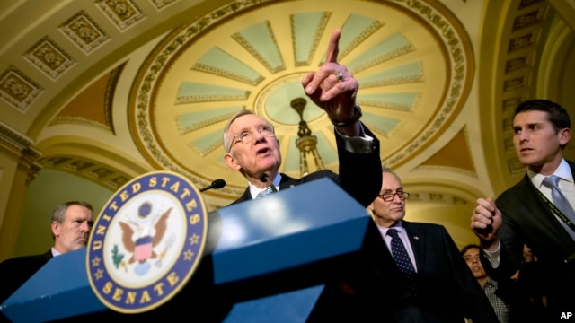 FILE - Senate Minority Leader Harry Reid (at podium) speaks during a news conference on Capitol Hill in Washington.