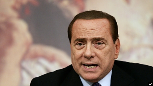 Italian Premier Silvio Berluconi talks to journalists during a press conference at the end of a Cabinet Ministers meeting on the approval of the new austerity measures, in Rome (File Photo - August 12, 2011)