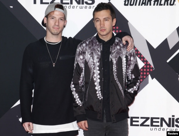 FILE - Twenty One Pilots pose on the red carpet during the MTV EMA awards at the Assago forum in Milan, Italy.