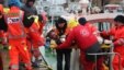 A rescued sailor is brought ashore in the harbor at Ravenna, Italy, Dec. 28, 2014.  