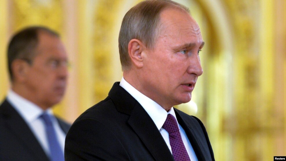 Le président russe Vladimir Poutine et son ministre des affaires étrangères Sergei Lavrov, arrière-plan, au Kremlin, Moscou, 9 novembre 2016.