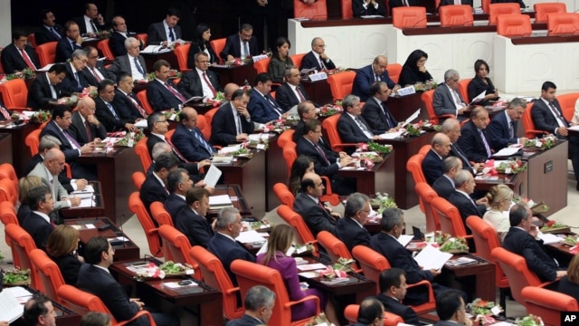 The newly-elected lawmakers from pro-Kurdish Peace and Democracy Party, last two rows, sit  the parliament with the members of other parties in Ankara, Turkey, October 1, 2011. 
