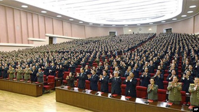 Delegates clap in union during the ruling Workers' Party representatives meeting in Pyongyang, North Korea, 28 Sep 2010