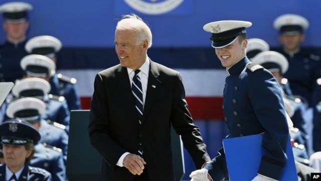 Air Force Number 1 Overall Graduating Cadet David McCarthy smiles after being congratulated by Vice President Joseph Biden during the commencement ceremony for the class of 2014, Wednesday, May 28, 2014.