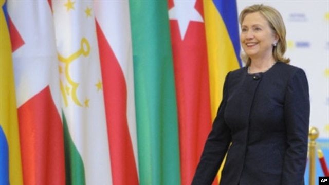US Secretary of State Hillary Clinton against the backdrop of OSCE country flags at the organization's summit in Astana, Kazakhstan, 01 Dec 2010