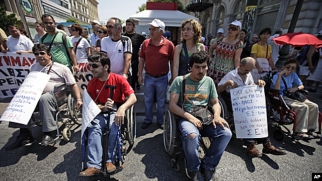 Protesters participate in a rally against the government's latest austerity measures and plans to sell off state enterprises in central Athens, June 18, 2011