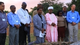Representatives of the Christian, Muslim, Hindu, and Buddhist faiths pray for Africa's wildlife at the historic Ivory Burning Site in Nairobi National Park, Kenya, September 20, 2012. (J. Craig/VOA)