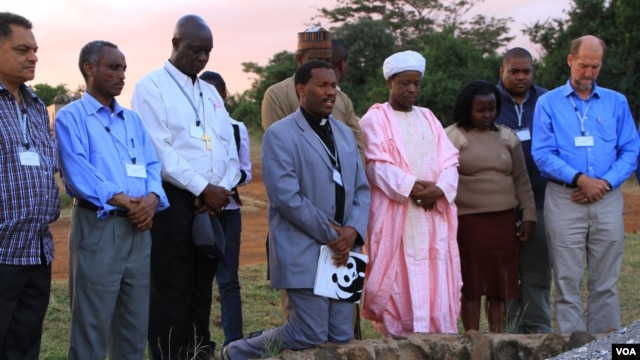 Representatives of the Christian, Muslim, Hindu, and Buddhist faiths pray for Africa's wildlife at the historic Ivory Burning Site in Nairobi National Park, Kenya, September 20, 2012. (J. Craig/VOA)