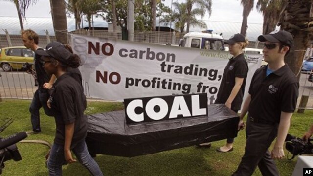 People walk with a coffin as they protest against the usage of coal during a climate change conference at the city of Durban, South Africa, December 1, 2011.