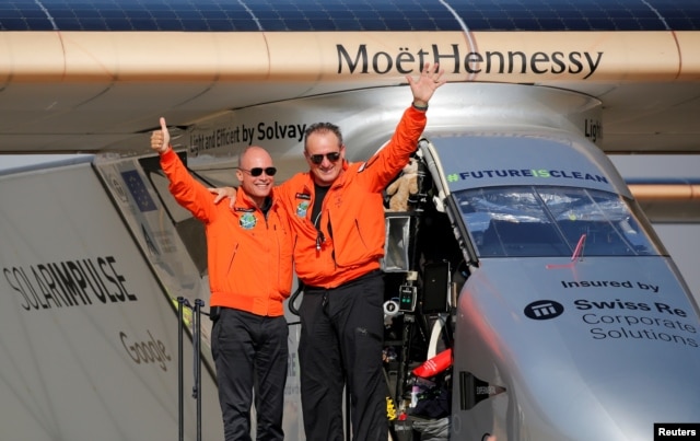 FILE - Andre Borschberg, right, the Swiss pilot of Solar Impulse 2, is greeted by fellow pilot and countryman Bertrand Piccard after landing at Cairo Airport, Egypt, July 13, 2016.