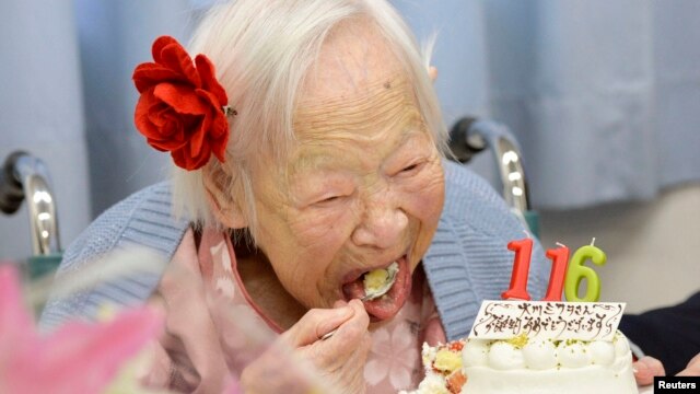 FILE - Japanese Misao Okawa, the world's oldest woman, eats her birthday cake as she celebrates her 116th birthday in Osaka, western Japan, in this photo taken by Kyodo March 5, 2014.