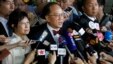 FILE - Donald Tsang, center, former leader of Hong Kong talks to reporters with his wife Selina as they leave a magistrate's court in Hong Kong, Oct. 5, 2015. Tsang faces misconduct charges over a luxury apartment rental in mainland China.