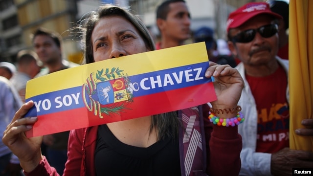  A supporter of Venezuelan President Hugo Chavez attends a gathering outside Miraflores Palace in Caracas, January 10, 2013. 
