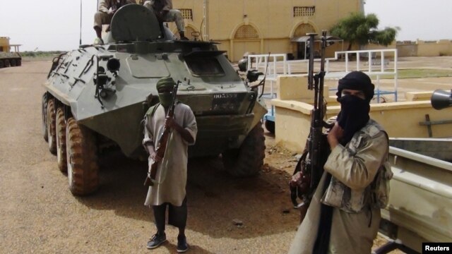 Fighters from the Al Qaeda-linked Islamist group MUJWA stand guard in Gao, northern Mali, August 7, 2012.