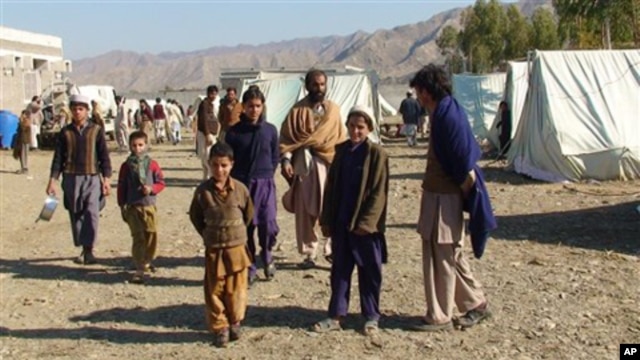 In this photo taken on Jan. 31, 2011, displaced Pakistanis arrived at a camp set up in Naghi, 18 kilometers northwest of the Afghanistan border in the Pakistani tribal area of Mohmand.
