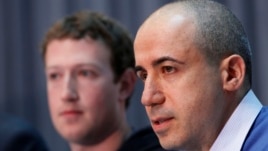 Russian entrepreneur and venture capitalist Yuri Milner (R) speaks while Facebook CEO Mark Zuckerberg looks on at the Life Sciences Breakthrough Prize announcement in San Francisco, California, Feb. 20, 2013. 