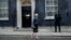 FILE - British Prime Minister Theresa May is seen walking outside 10 Downing Street in London, Nov. 9, 2016. A legislative aide was photographed in Downing street carrying hand-written notes some say offer insights into London's Brexit strategy.