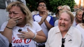 Supporters of the late Paraguayan presidential candidate Lino Cesar Oviedo react outside the morgue where his remains were taken after he died in a helicopter crash in Asuncion, Paraguay, Sunday, Feb. 3, 2013.