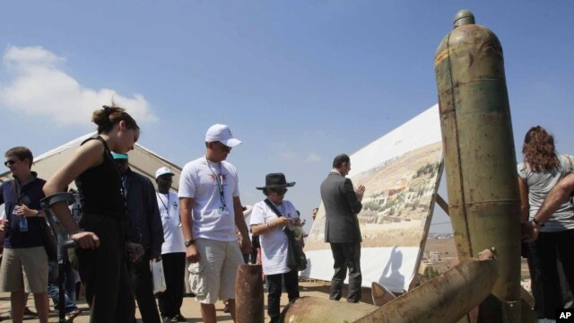 Activists and international delegations look at cluster bomb units during a visit to a Lebanese military base, Nabatiyeh, Lebanon, September 11, 2011.
