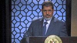 Egypt's President-elect Mohamed Morsi speaks during his first televised address to the nation at the Egyptian Television headquarters, Cairo June 24, 2012.