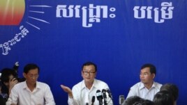 Cambodia National Rescue Party leader Sam Rainsy (middle) talks during a press conference on Thursday, August 29, 2013.   