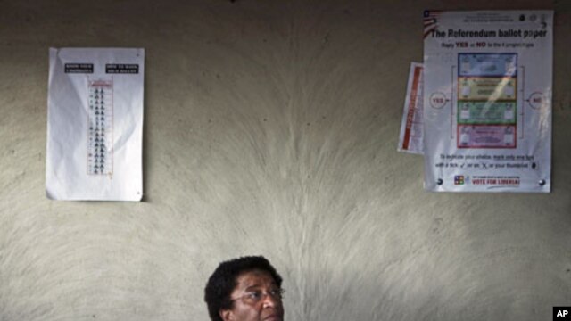 Nobel Peace Prize Laureate and incumbent leader Ellen Johnson-Sirleaf sits at a resident's home after voting during presidential elections at her home village of Fefee outside the capital Monrovia, Liberia, November 8, 2011.