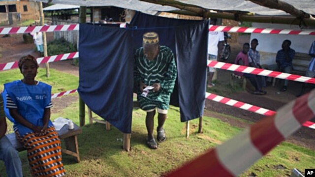 A Liberian man exits a polling booth for the presidential election run-off at Klay town just outside the capital Monrovia, November 8, 2011