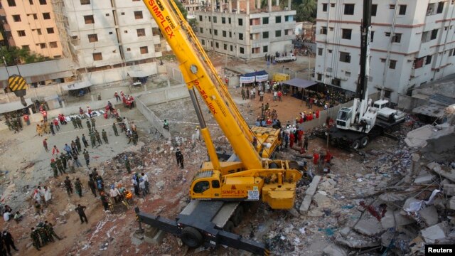 Army soldiers clear up the rubble of the collapsed Rana Plaza building with a crane in Savar, 30 km (19 miles) outside Dhaka, Apr. 28, 2013.