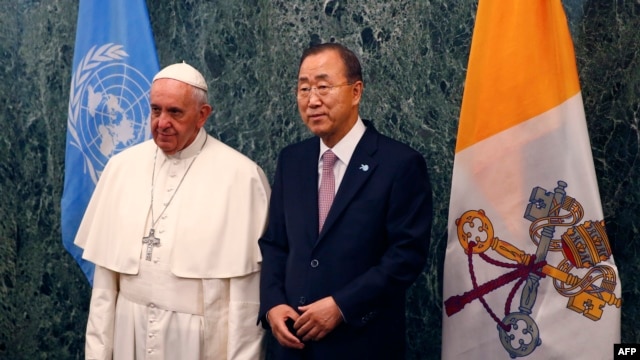 Pope Francis, left, poses with United Nations Secretary-General Ban Ki-moon at U.N. headquarters in New York, Sept. 25, 2015.