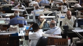 Diamond dealers work on the trading floor of Israel's diamond exchange in Ramat Gan near Tel Aviv, October 30, 2012.