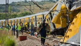 Emergency workers in attendance at the scene of a collision between two passenger trains near Pretoria, South Africa, January 31, 2013.