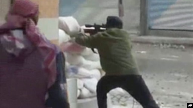 A rebel fires a weapon around a corner at Syrian government forces in Damascus, Syria, December 7, 2012.