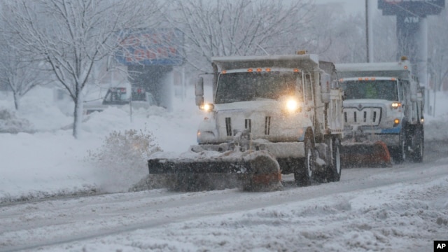 City snow plows clear 23rd Street in Lawrence, Kansas, Feb. 26, 2013.  