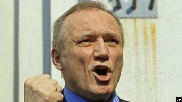 Former presidential candidate Vladimir Neklyaev gestures as he speaks to the media after leaving a court building in Minsk, Belarus, May 20, 2011