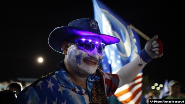 A pro-statehood New Progressive Party supporter waves his party's flag during their closing campaign rally in San Juan, Puerto Rico, November 3, 2012.